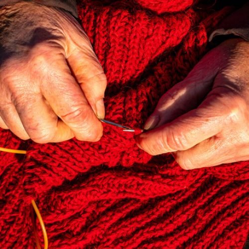 stock-photo-hand-knitting-woolen-thread-knitting-needles-warm-clothes-knitting-needles